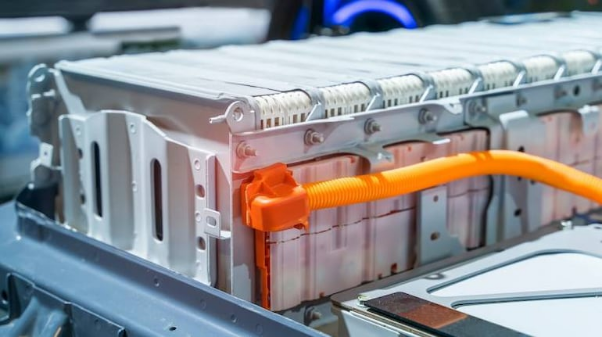 An electric car battery connected to a charger, indicating the charging process in progress